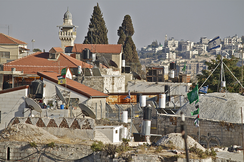 Green Hamas flags whip in the wind over Jerusalem’s Old City