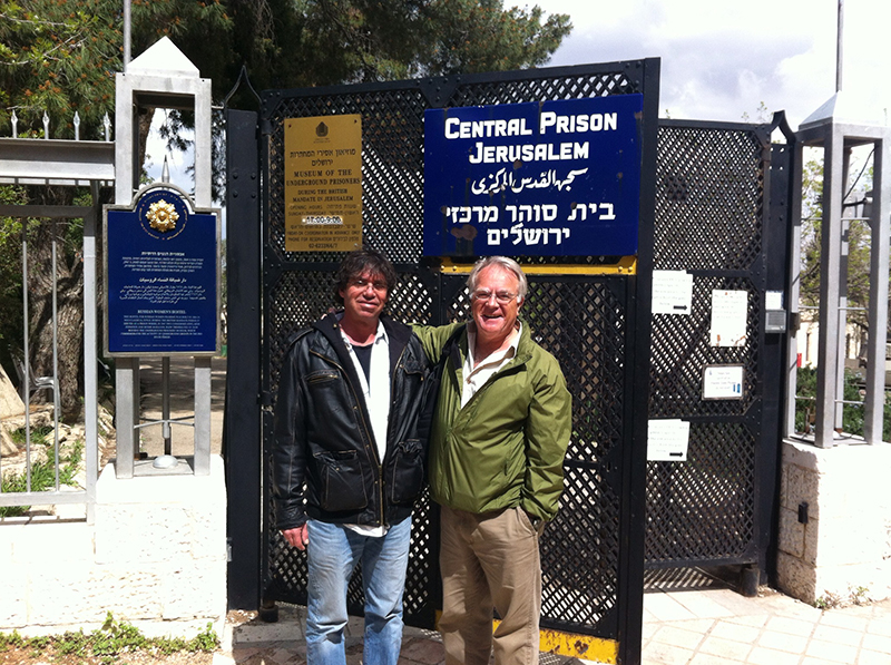 Yoram and Gary stand in front of the prison gates