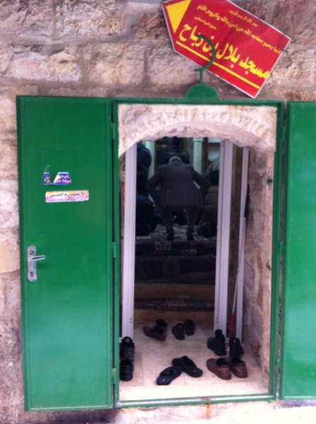 In one of many newly opened “mini” mosques invading the bowels of the Old City, a collection of men’s shoes clutter the threshold as faithful bow to pray