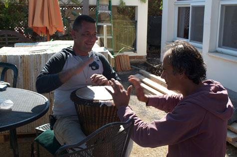 Our Arab concrete man, Hussam, and Tzion, our Jewish electrician, enjoy a break to make music together on my djembe drum