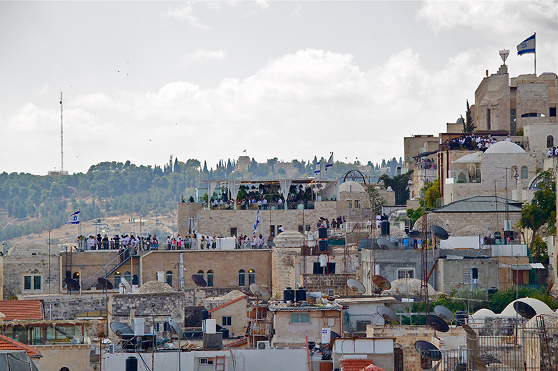 Crowds gather for a holiday message on rooftops and under an enormous “sukkah” eight floors above the Western Wall